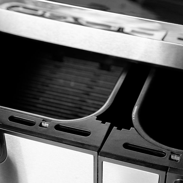 Modern black air fryer with an open basket on a clean kitchen worktop, illustrating how to clean an air fryer.